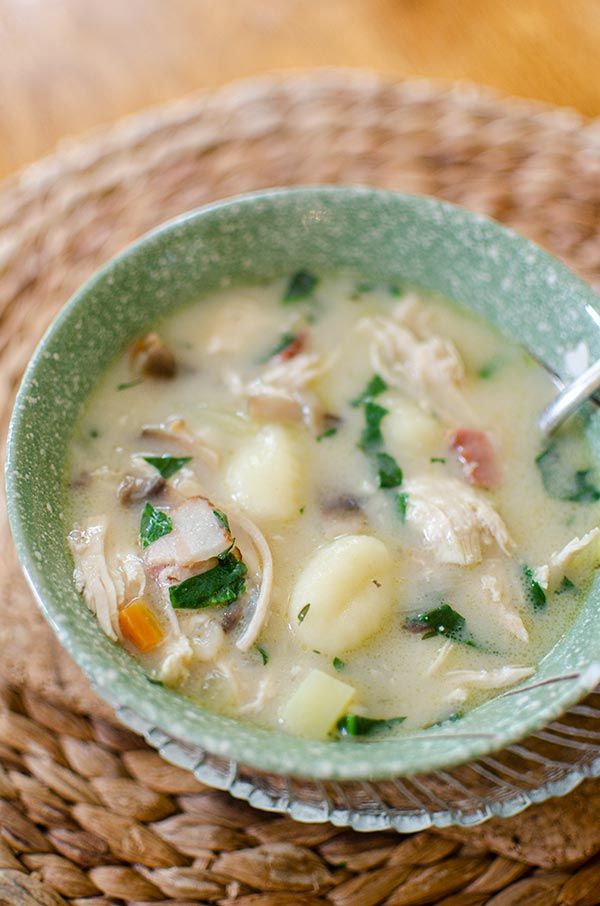 Chicken gnocchi soup in a bowl with a spoon