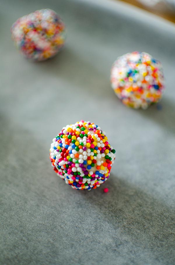 Raw cookie dough ball rolled in sprinkles