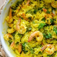 Coconut turmeric rice with shrimp and thinly sliced kale.