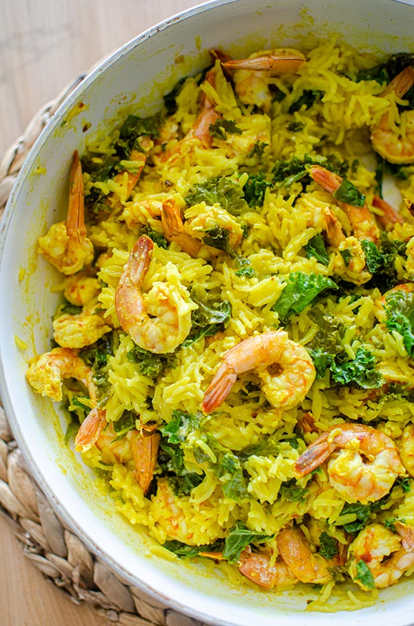 Coconut turmeric rice with shrimp and thinly sliced kale.