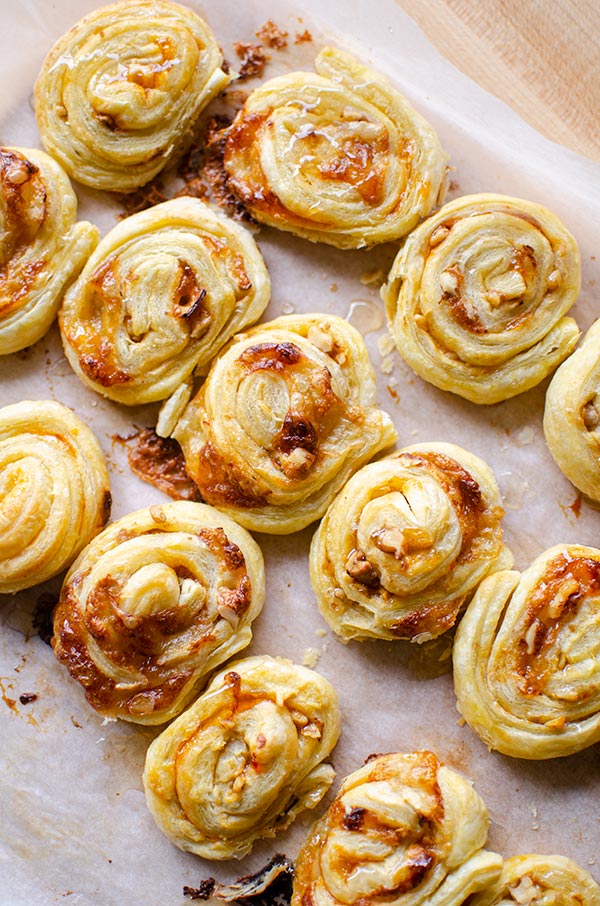 Baked puff pastry brie bites on a baking sheet.