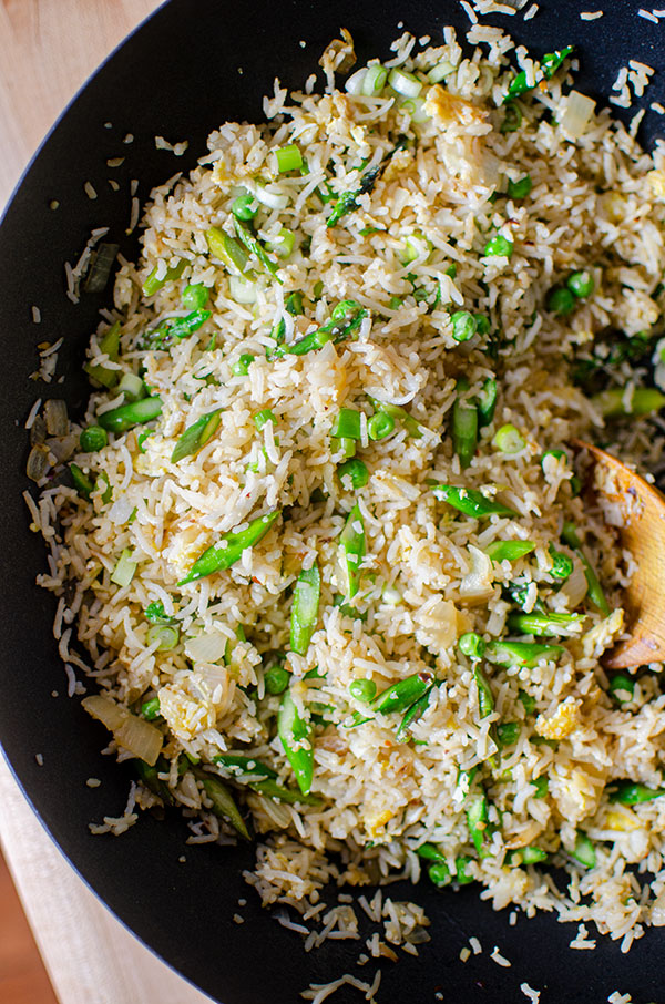 Fried rice with asparagus and peas in a wok