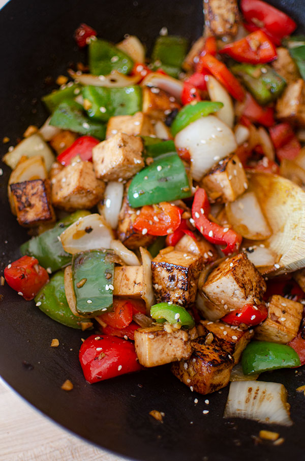 Tofu bell pepper stir fry in a wok.