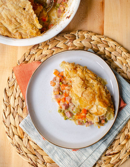 A slice of ham pot pie on a plate