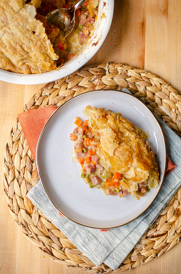 A slice of ham pot pie on a plate