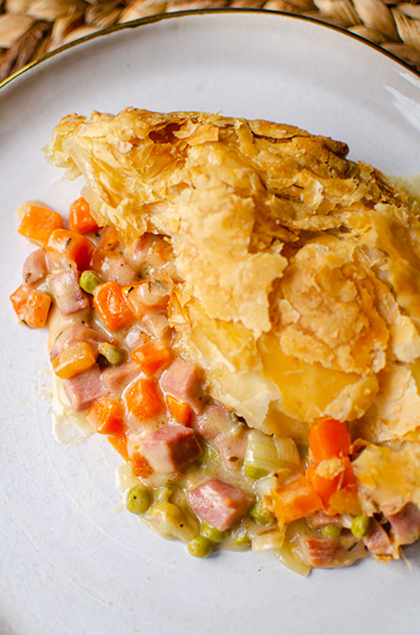 Close up of pot pie with filling on a plate.