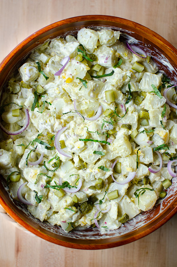 Potato salad in a brown wooden bowl
