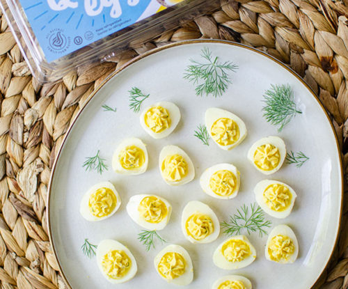 plate of deviled quail eggs with spring creek carton