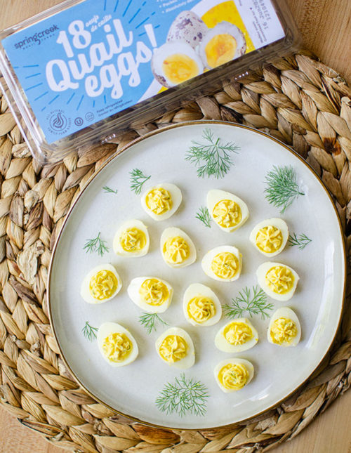 plate of deviled quail eggs with spring creek carton