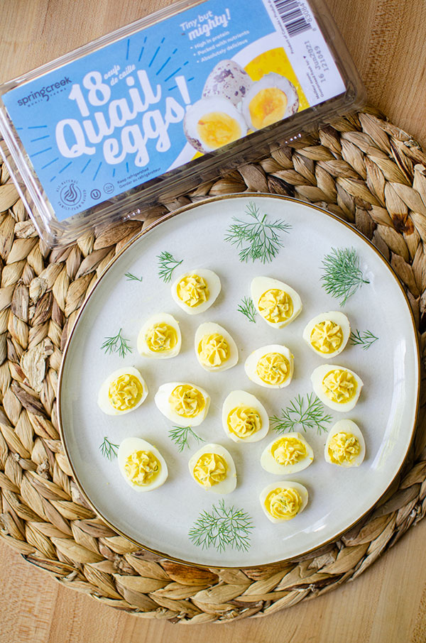 plate of deviled quail eggs with spring creek carton