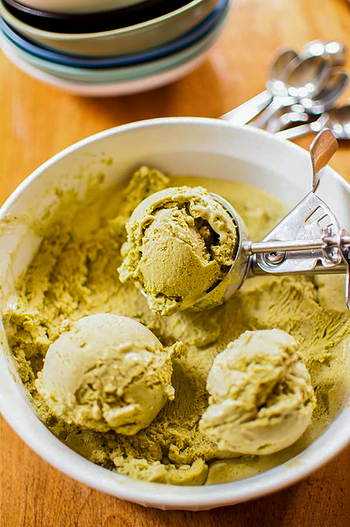 Matcha ice cream scoops in a bowl