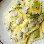 A portion of ravioli with mushroom cream sauce