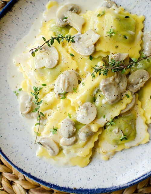 A serving of ravioli on the plate with fresh thyme
