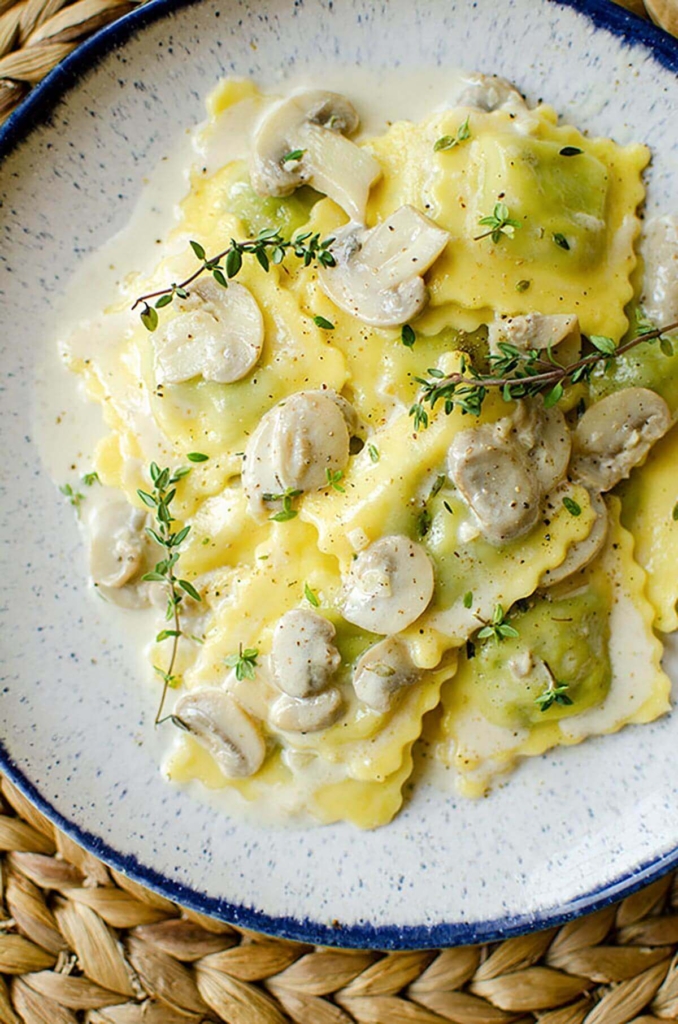 A serving of ravioli on the plate with fresh thyme