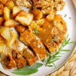 Closeup of chicken with gravy, potatoes and stuffing.