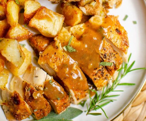 Closeup of chicken with gravy, potatoes and stuffing.