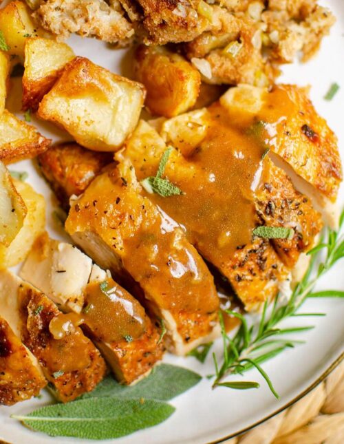 Closeup of chicken with gravy, potatoes and stuffing.