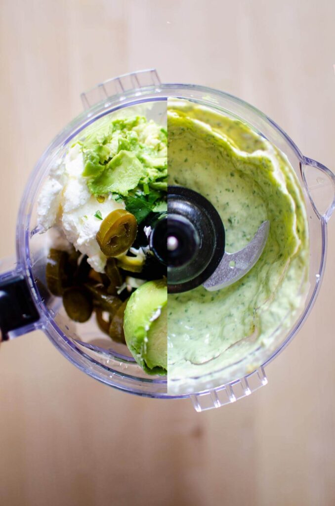 A food processor with the ingredients half blended half whole.