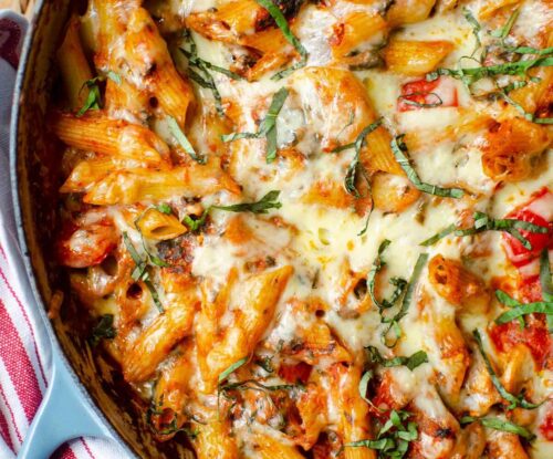 Closeup of baked ziti in blue dish.