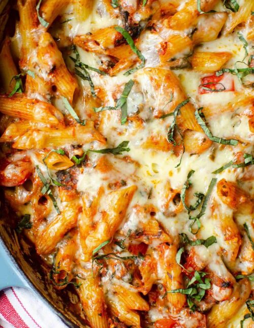 Closeup of baked ziti in blue dish.