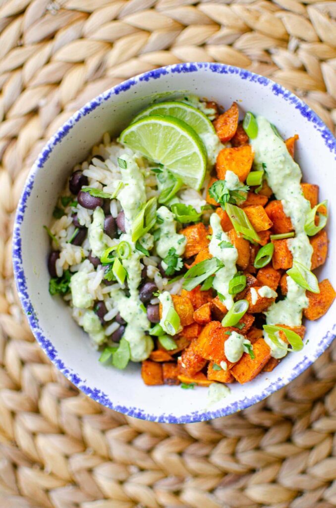 A serving of the sweet potato bowl in a white bowl with a blue rim.