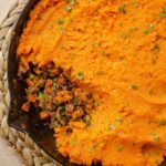 Closeup of sweet potato shepherd's pie with a piece missing.