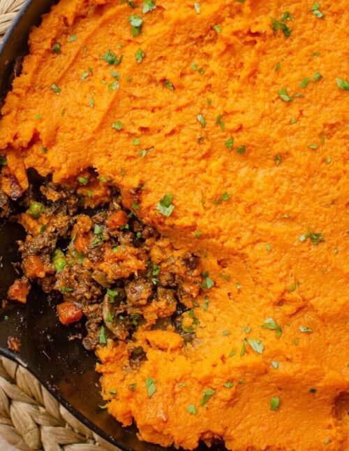 Closeup of sweet potato shepherd's pie with a piece missing.