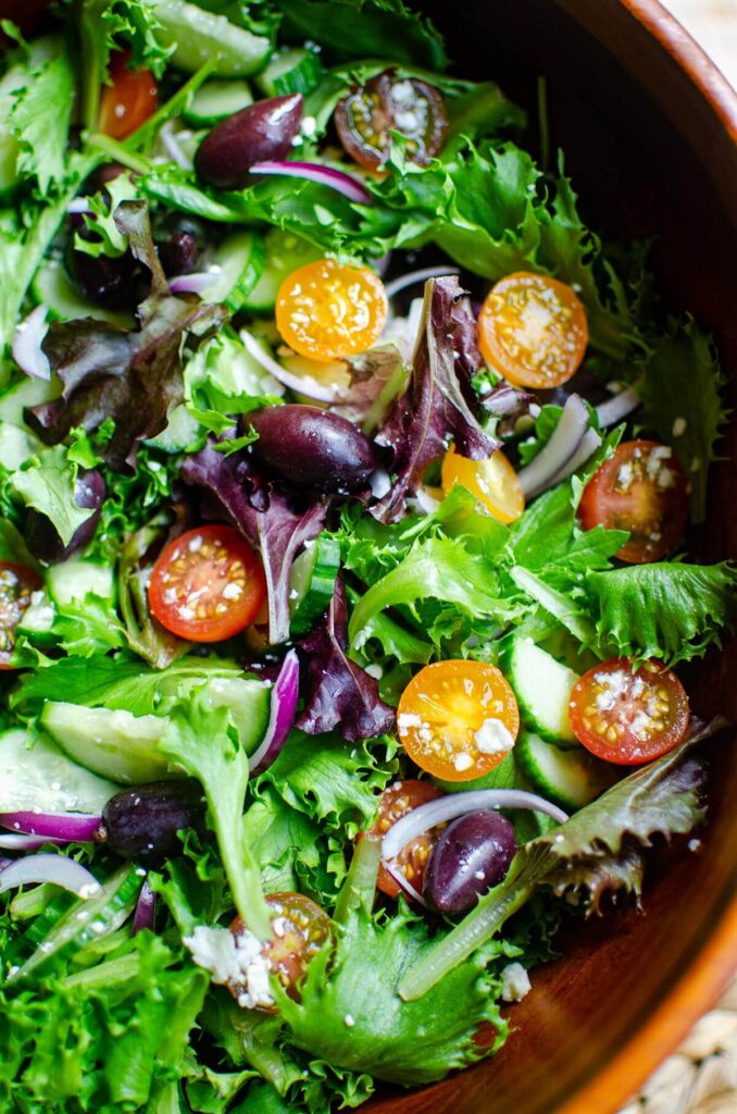 Closeup of salad in a wooden bowl.