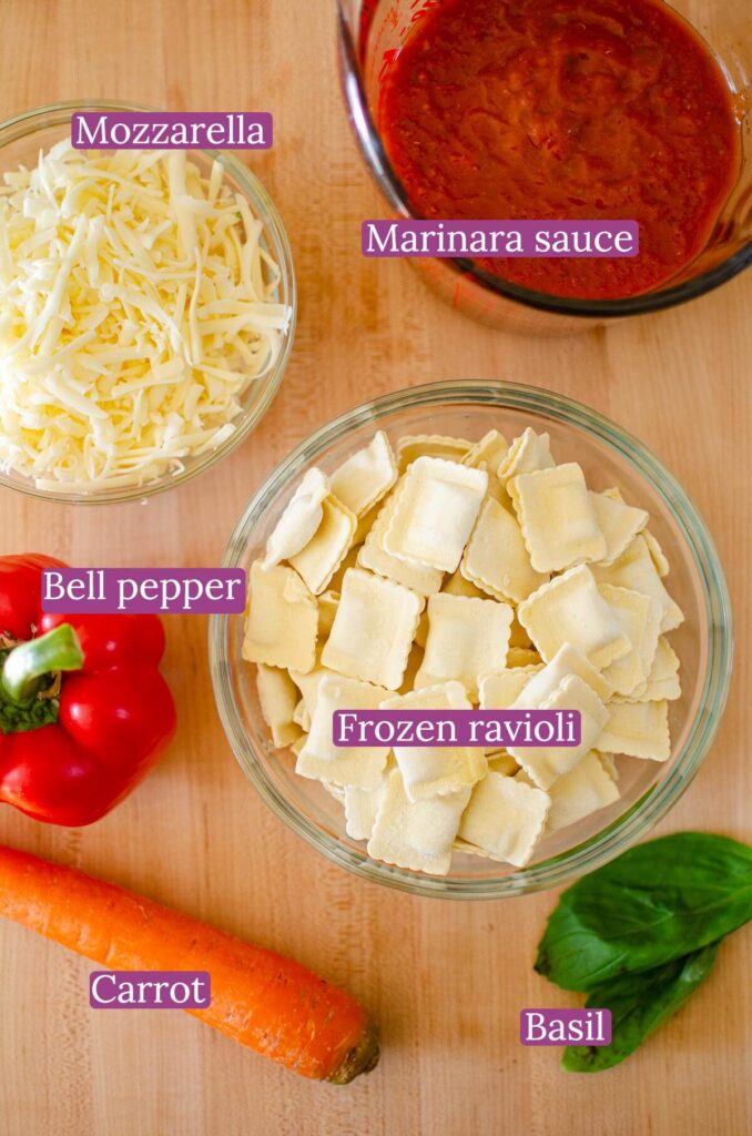 Ingredients for lasagna on a wooden board.