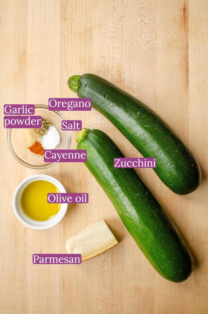 Ingredients for sliced zucchini on a wooden board.