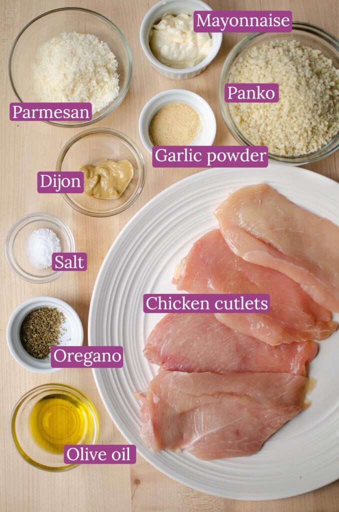 Ingredients for panko chicken on a cutting board.