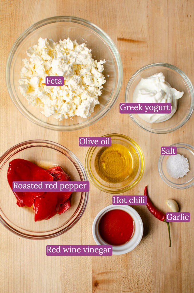 Ingredients in glass bowls on a wooden board.