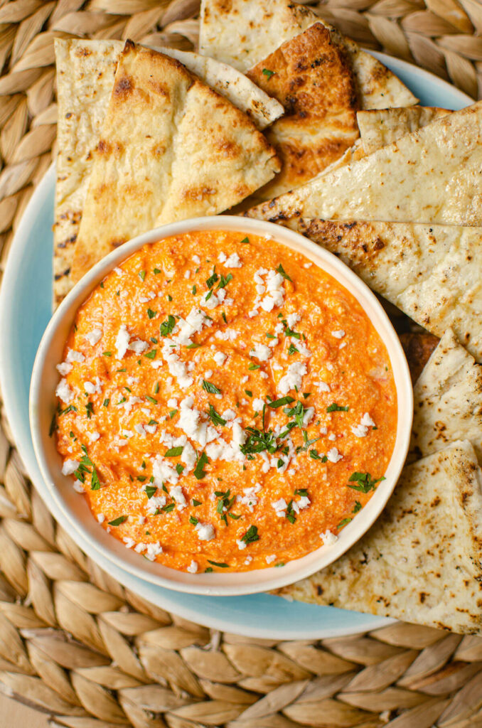 Dip in a white bowl with gilled pita slices.