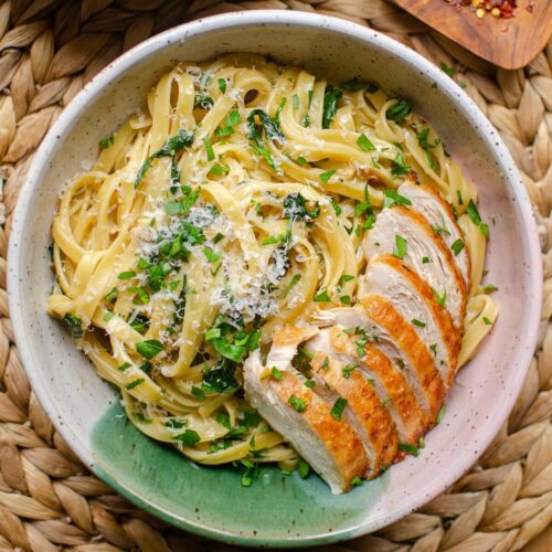 Closeup of a plate of pasta with chicken.