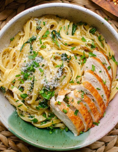 Closeup of a plate of pasta with chicken.